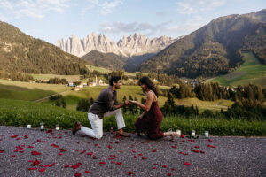Man proposed to his girlfriend with rose petals and candles and Val di Funes in the background