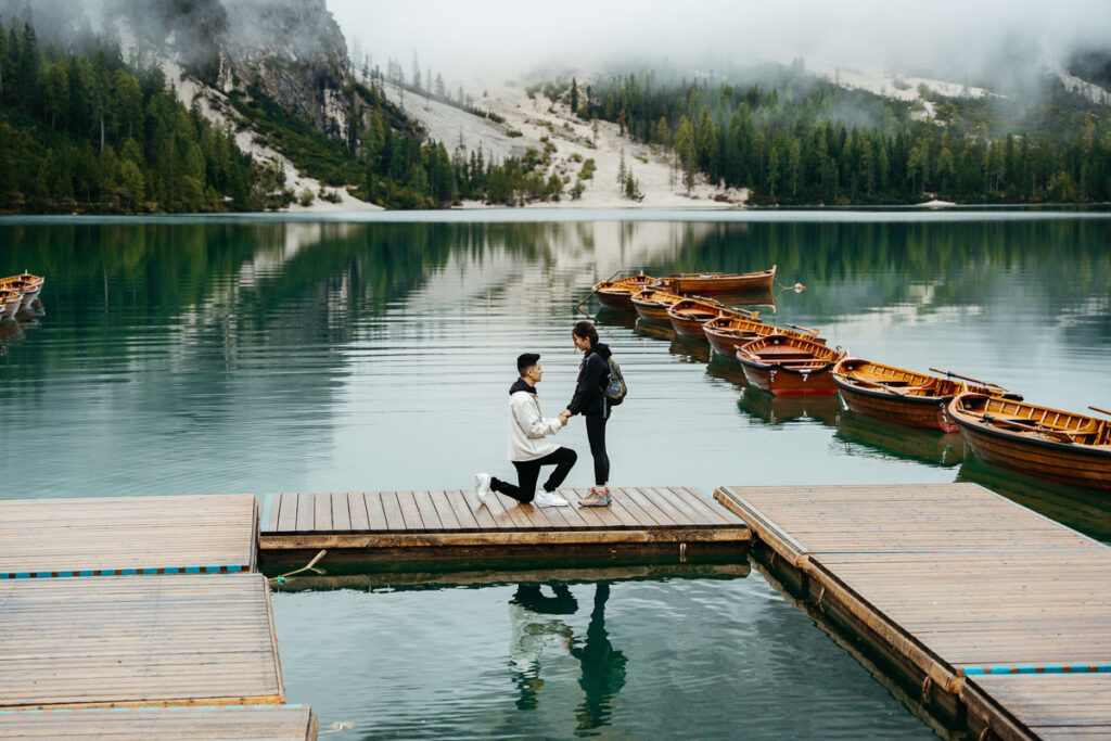Man proposing to his girlfriend at Lago di Braies, one of the best places to propose in Europe