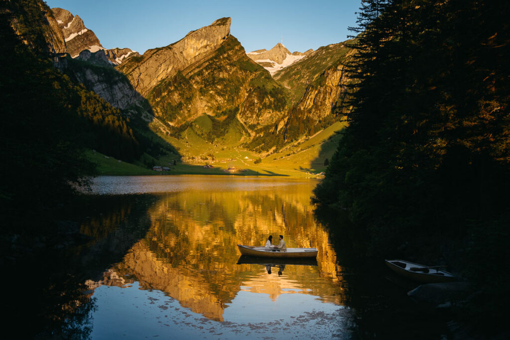 Sunrise at Seealpsee with bride and groom in rowboat on the lake; How to Elope in Switzerland