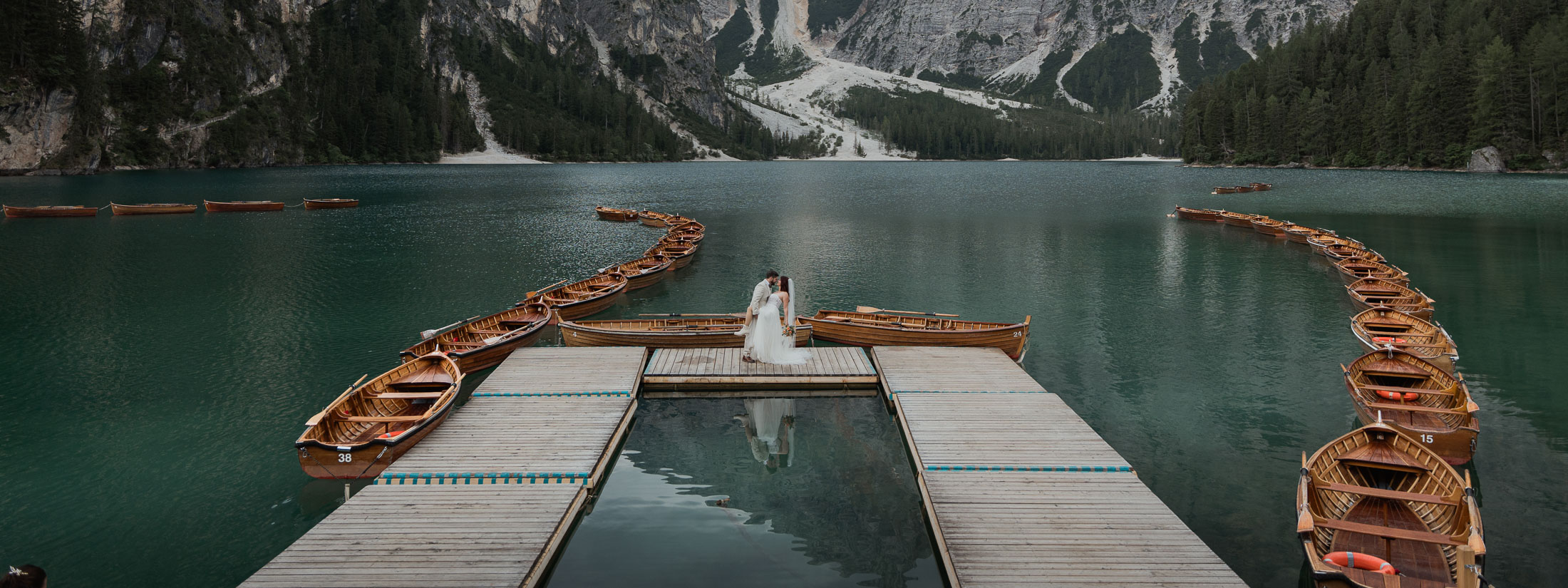 Husband and wife posing at Lago di Braies after they renewed their vows to each other