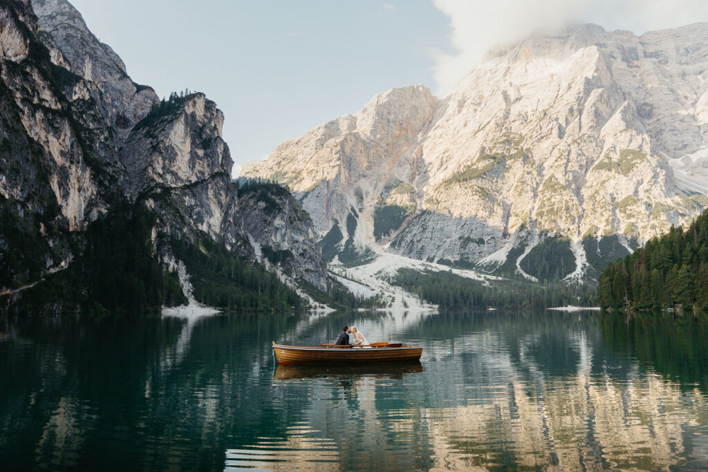 Bride and groom standing in boat from La Palifitta at Lake Braies