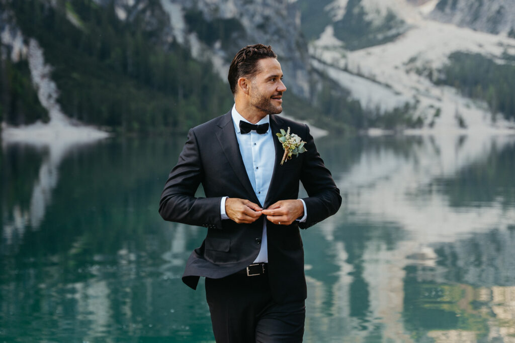 Groom wearing black suit with bowtie during his elopement on Lago di Braies