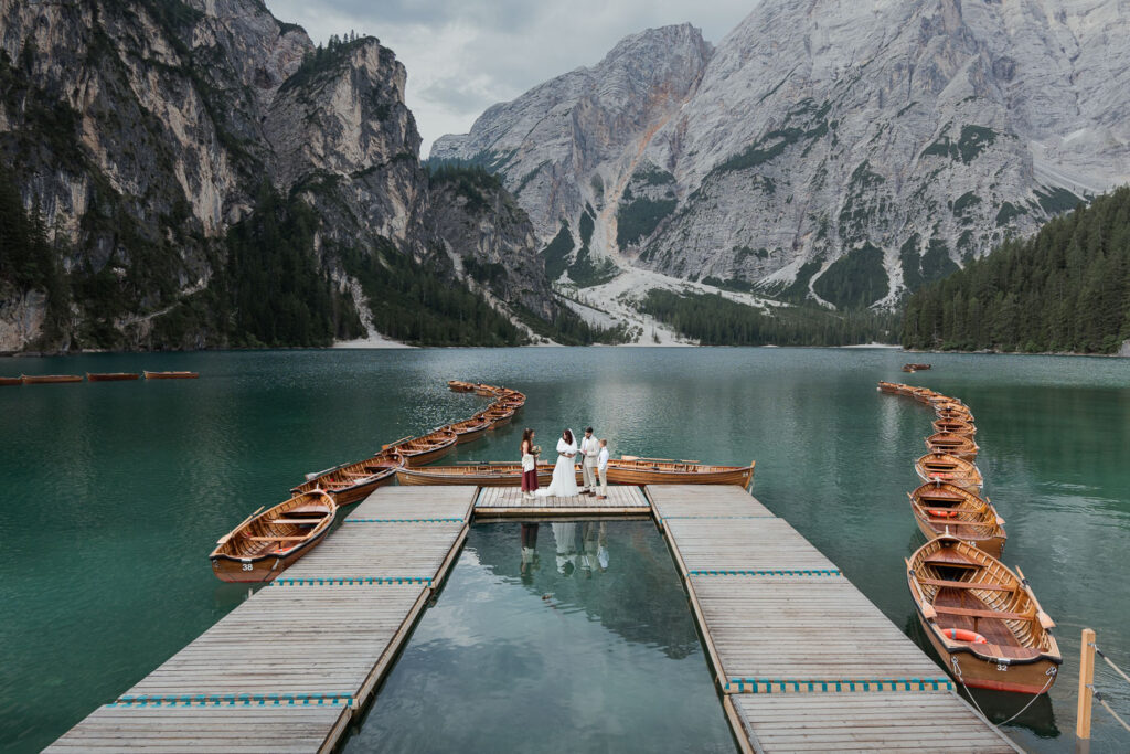 Family hugging with bride and groom at Lago di Braies. Why you should have a multi-day elopement