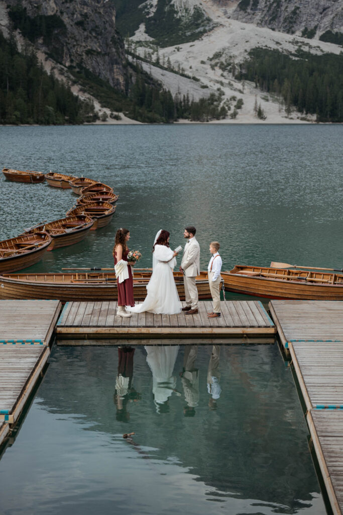Vow renewal of husband and wife with their kids on Lago di Braies dock