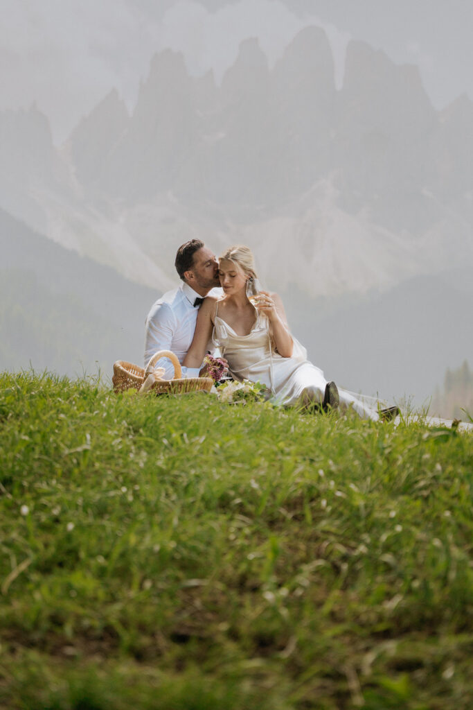 Bride and groom having a sustainable picnic on Val di Funes