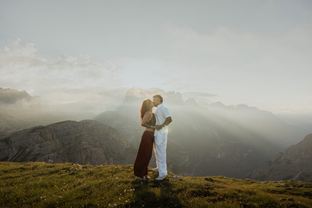Man proposing in an adventurous way to girlfriend on a mountain top at Cadini di Misurina