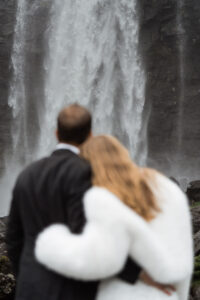 Fossà in focus with bride and groom embracing each other out of focus