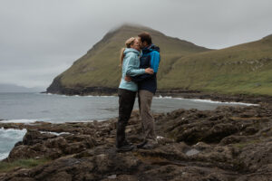 Bride and groom in hiking attire at Gjógv on Faroe Island