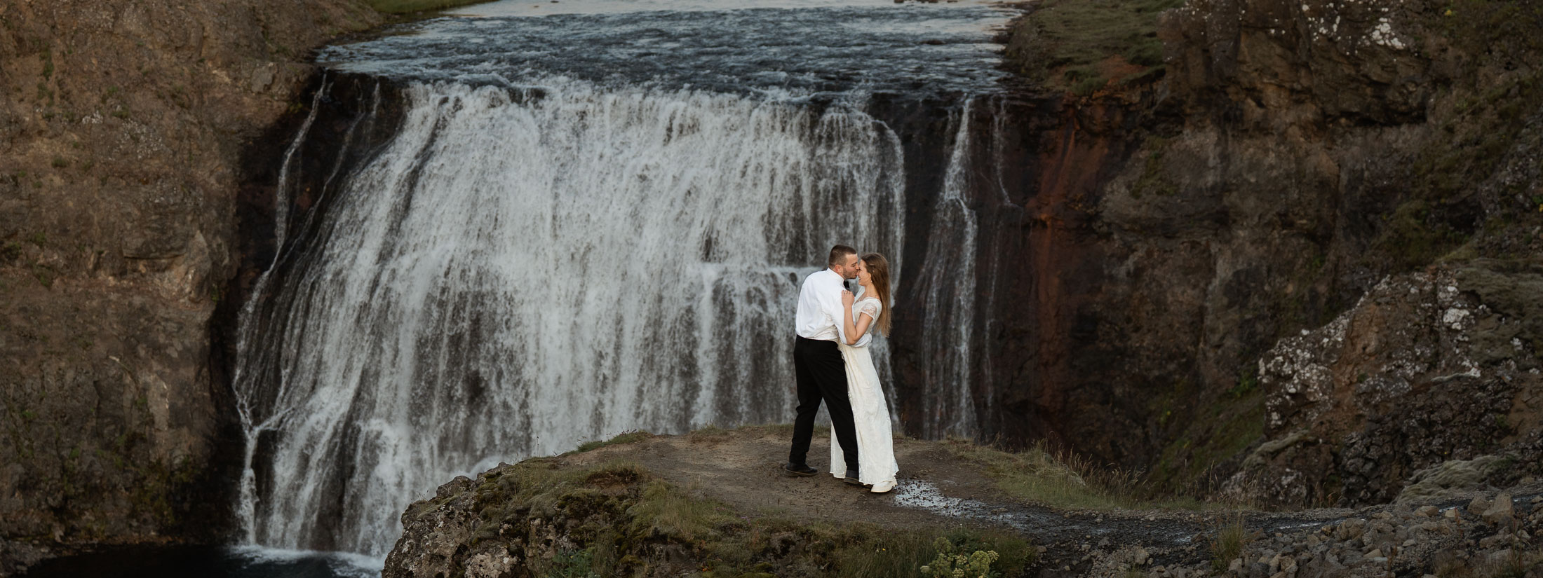 Bride and groom dancing in front of Þórufoss after they eloped at Thingvellir national park in Iceland