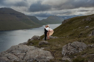 Bride and groom wanted a cool summer elopement to escape the heatwaves and fires, so here they are eloping in Faroe Islands on Klakkur with the mountains and Fjords in the background