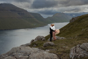 Bride and groom embracing the wind at Klakkur during their elopement
