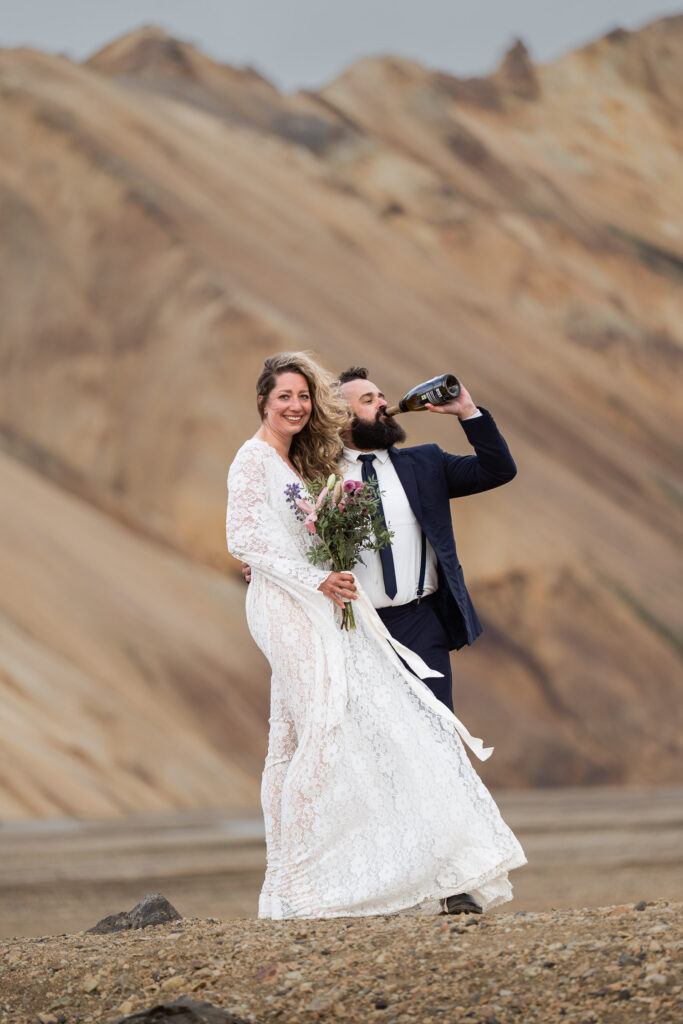 Bride and groom after poppoing champagne at Landmannalauger in Iceland