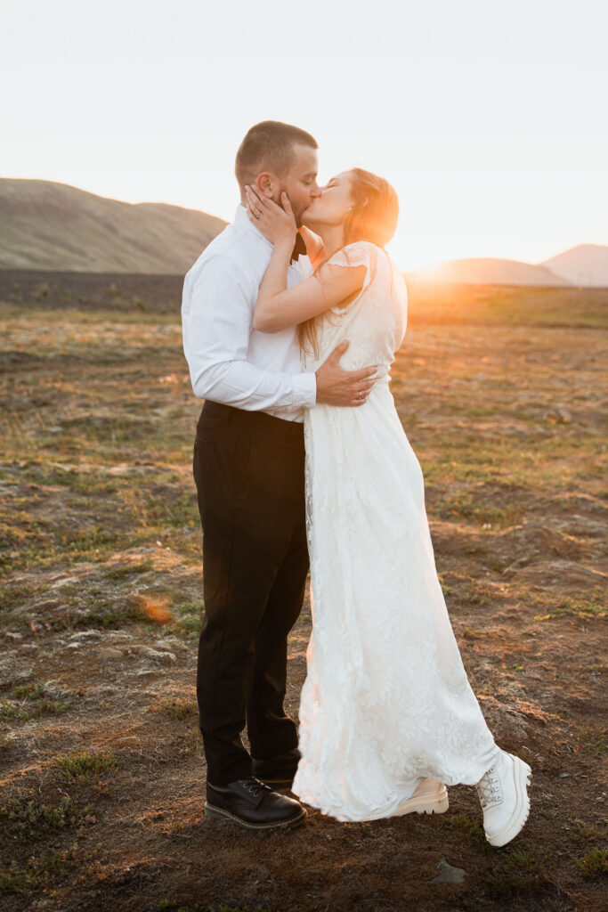Bride and groom kissing during sunset; How to Elope in Iceland