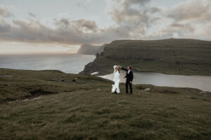 Groom spinning bride during their elopement at Trælanípa on the Faroe Islands