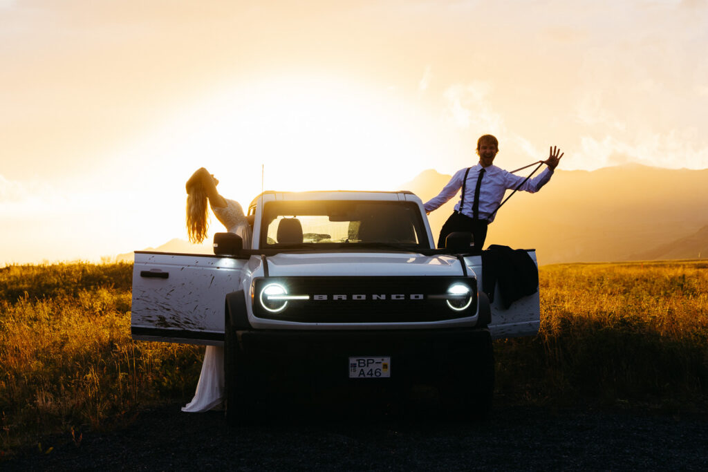 Bride and groom posing with 4x4 elopement truck in Iceland