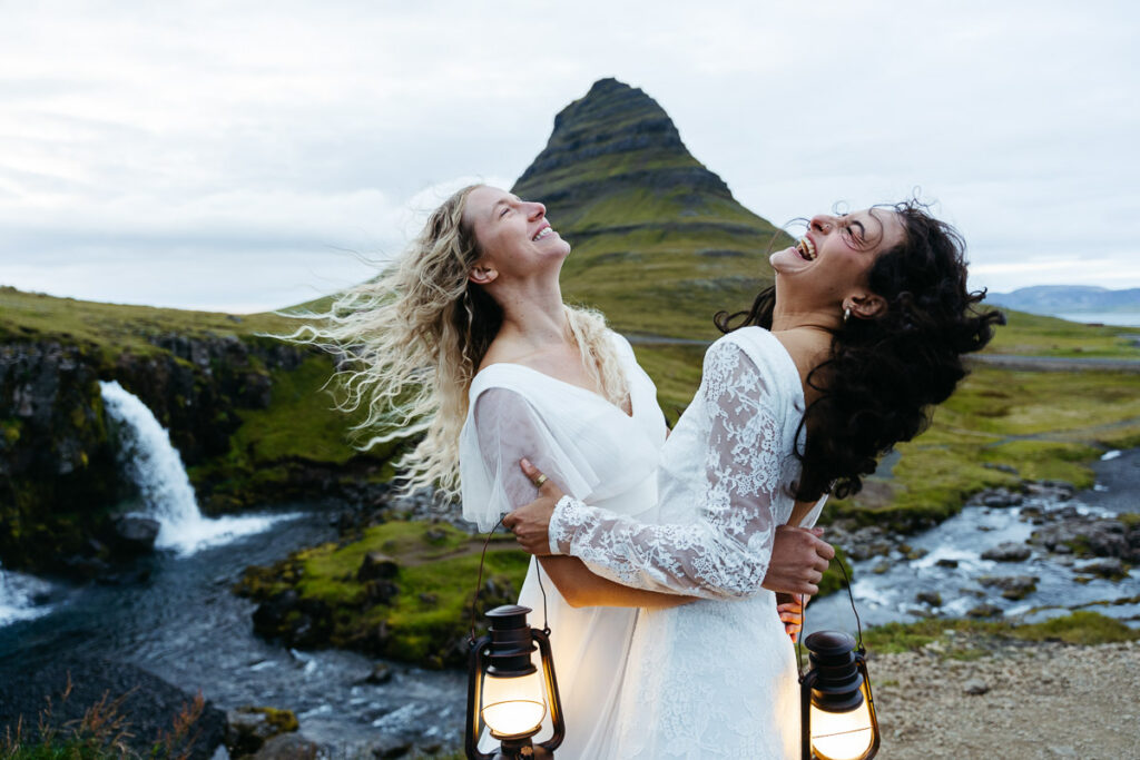 Bride's shaking their hair in the wind at Kirkjufell in Iceland