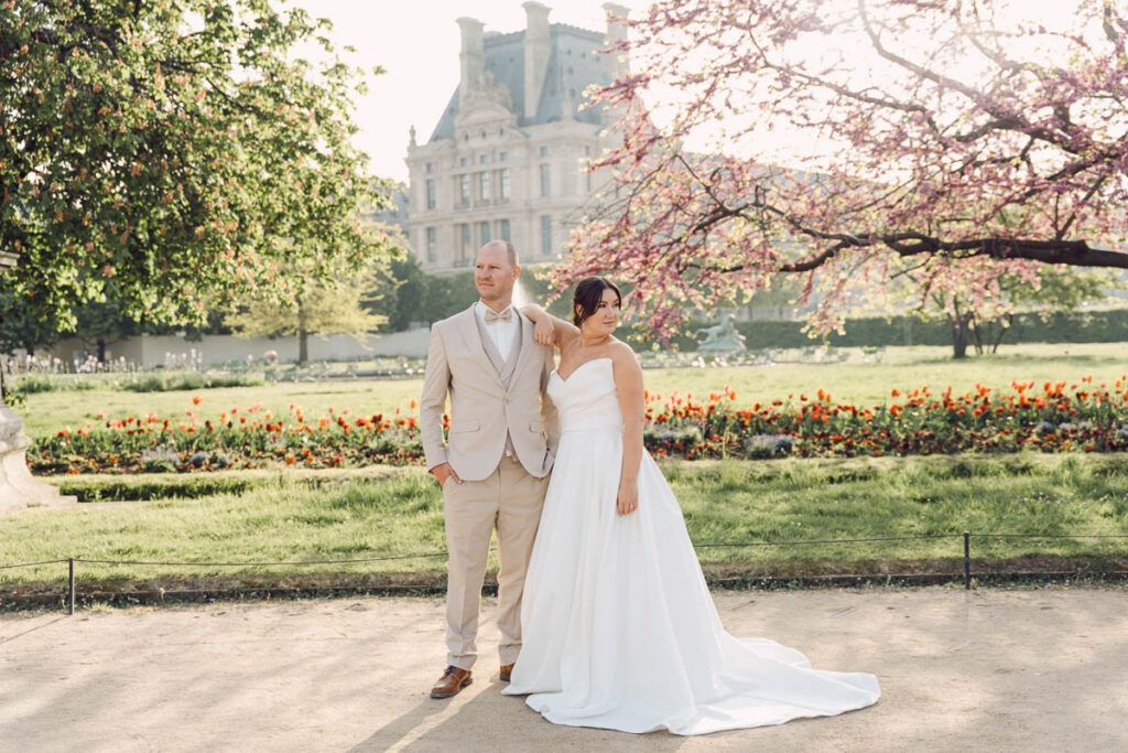 Bride and groom leaning on each other at Tuileries Garden; How to Elope in Paris