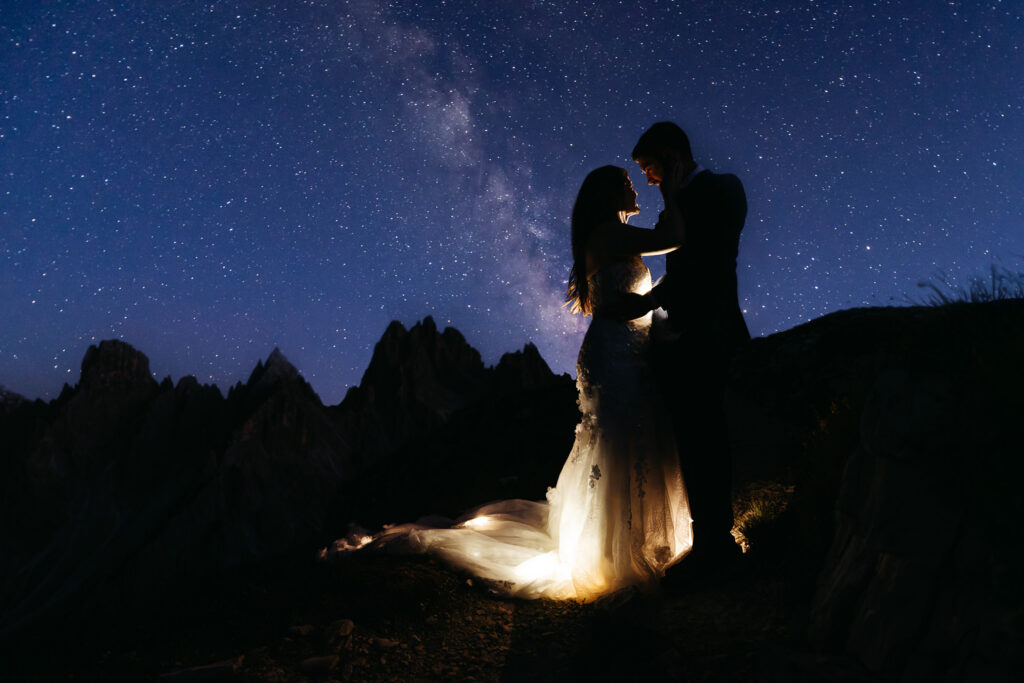 Bride and groom with starry mountain background in the Dolomites; Best Places to Elope on a Mountain in Europe