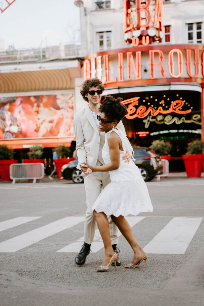Bride and groom dancing in front of Moulin Rouge; How to Elope in Paris